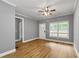 Spacious living room features hardwood floors, natural light and a ceiling fan at 3111 Jones St, East Point, GA 30344