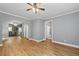 Open living room features hardwood floors, and views into the kitchen and bedroom hallway at 3111 Jones St, East Point, GA 30344