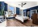 Comfortable bedroom featuring hardwood floors, a ceiling fan, and large windows at 57 Forsyth Nw St # 11G, Atlanta, GA 30303