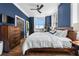 Inviting bedroom showcasing a queen-sized bed, hardwood floors, and black painted doors at 57 Forsyth Nw St # 11G, Atlanta, GA 30303