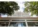 Exterior view of building showcasing architectural details against blue sky and treetops at 57 Forsyth Nw St # 11G, Atlanta, GA 30303