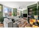 Stylish living room featuring a plush sofa, modern decor, city views, built-in shelves, and hardwood floors at 57 Forsyth Nw St # 11G, Atlanta, GA 30303
