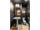 Elegant powder room with pedestal sink, decorative wallpaper, and classic fixtures at 57 Forsyth Nw St # 11G, Atlanta, GA 30303