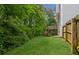 A view of the backyard with trees, a wooden fence, and a deck with stairs leading down to the yard at 111 Trellis Ct, Acworth, GA 30101