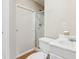 Small bathroom featuring wood-look floor, a shower, and a small, white sink and vanity at 111 Trellis Ct, Acworth, GA 30101