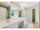 Bathroom with a double vanity, large mirror, tile flooring, and access to a closet at 111 Trellis Ct, Acworth, GA 30101