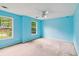 Blue bedroom with natural light streaming in from two windows, and a ceiling fan at 111 Trellis Ct, Acworth, GA 30101