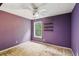 Cozy bedroom with lilac walls, a ceiling fan, and a window providing natural light at 111 Trellis Ct, Acworth, GA 30101