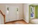 Bright entryway featuring hardwood floors, white door with sidelights, and adjacent room at 111 Trellis Ct, Acworth, GA 30101