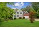 Beautiful two-story home featuring manicured lawn, grey siding, brick details, and inviting curb appeal at 111 Trellis Ct, Acworth, GA 30101