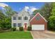 Charming two-story home with gray siding, brick accents, and a well-manicured front lawn at 111 Trellis Ct, Acworth, GA 30101