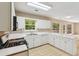 Bright kitchen features white cabinets, modern appliances, and a large window offering natural light at 111 Trellis Ct, Acworth, GA 30101