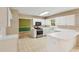 Well-lit kitchen featuring white cabinets, stainless steel appliances, and tile flooring at 111 Trellis Ct, Acworth, GA 30101