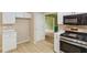 Well-lit kitchen features white cabinetry, modern appliances, and an easy to clean tile floor at 111 Trellis Ct, Acworth, GA 30101