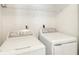 Laundry area featuring full size washer and dryer with wire shelving above at 111 Trellis Ct, Acworth, GA 30101