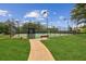 Community tennis court with green surface and surrounding fence at 111 Trellis Ct, Acworth, GA 30101