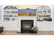 Cozy living room with a fireplace, built-in shelving, hardwood floors, and a television at 270 Morrow Rd, Newborn, GA 30056