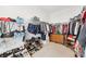 Walk-in closet provides ample hanging space, shoe racks and storage shelving at 270 Morrow Rd, Newborn, GA 30056