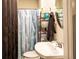 Bathroom featuring vanity sink and blue and purple shower curtain at 361 N Dogwood N Ave, Social Circle, GA 30025