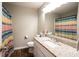 Bathroom featuring granite countertop, single sink, and colorful shower curtain at 361 N Dogwood N Ave, Social Circle, GA 30025