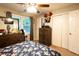 Bedroom with ceiling fan, dresser, closet, and window, offering ample storage at 361 N Dogwood N Ave, Social Circle, GA 30025