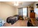 Cozy bedroom with neutral walls, carpet floors, and a single bed by the window at 361 N Dogwood N Ave, Social Circle, GA 30025