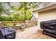 Wooden deck for outdoor enjoyment, featuring a dining area and a grill at 361 N Dogwood N Ave, Social Circle, GA 30025