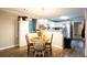 Bright dining area featuring wood-look flooring and an open view into the modern kitchen at 361 N Dogwood N Ave, Social Circle, GA 30025