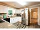 Bright kitchen with stainless steel refrigerator, granite countertops, and white cabinets at 361 N Dogwood N Ave, Social Circle, GA 30025