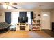 Bright living room features a ceiling fan, plush seating, and large window at 361 N Dogwood N Ave, Social Circle, GA 30025