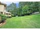 Sprawling backyard with lush green lawn and mature trees, perfect for outdoor activities at 3641 Mountain Cove Rd, Snellville, GA 30039