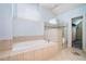 Bathroom featuring a soaking tub, glass-enclosed shower, and tile flooring at 3641 Mountain Cove Rd, Snellville, GA 30039