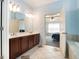 Bathroom boasting a double vanity, tile floor, and view to the Main Bedroom at 3641 Mountain Cove Rd, Snellville, GA 30039