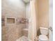 Bathroom featuring custom-tiled shower with built-in niche and seat, exuding quality and style at 3641 Mountain Cove Rd, Snellville, GA 30039