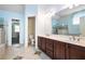 Ensuite bathroom with double sink vanity, tile floors, and separate shower and toilet rooms at 3641 Mountain Cove Rd, Snellville, GA 30039