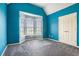 Bright bedroom with blue walls, a bay window, plush carpet and a double-door closet at 3641 Mountain Cove Rd, Snellville, GA 30039