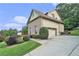Charming exterior showcasing the brick and siding, with mature landscaping and a convenient driveway leading to the garage at 3641 Mountain Cove Rd, Snellville, GA 30039
