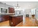 Open kitchen with granite countertops, a center island, and hardwood floors at 3641 Mountain Cove Rd, Snellville, GA 30039