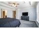 Large bedroom with a tray ceiling, plush carpet, and natural light at 3641 Mountain Cove Rd, Snellville, GA 30039