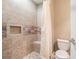 Shower with decorative tile accents, a built-in shelf, and a shower bench at 3641 Mountain Cove Rd, Snellville, GA 30039
