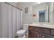Well-lit bathroom featuring shower/tub combo, single sink vanity with wood-look tile flooring at 4251 Haywater Cv, Buford, GA 30519