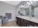 Well-lit bathroom featuring double sink vanity with wood-look tile flooring at 4251 Haywater Cv, Buford, GA 30519