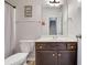 Well-lit bathroom featuring shower/tub combo, single sink vanity with wood-look tile flooring at 4251 Haywater Cv, Buford, GA 30519