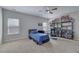 Comfortable bedroom featuring carpet flooring, ceiling fan, and closet space at 4251 Haywater Cv, Buford, GA 30519