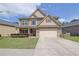 Charming two-story home with manicured lawn, inviting entryway, and neutral exterior paint at 4251 Haywater Cv, Buford, GA 30519