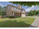 Charming home with manicured lawn and mature trees along a sidewalk at 4251 Haywater Cv, Buford, GA 30519