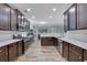 Spacious kitchen featuring stainless steel appliances, dark wood cabinets, and subway tile at 4251 Haywater Cv, Buford, GA 30519
