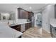 Modern kitchen with stainless steel appliances, white subway tile, and dark wood cabinets at 4251 Haywater Cv, Buford, GA 30519