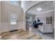 Bright living room with hardwood floors, wainscoting, transom window, and natural light at 4251 Haywater Cv, Buford, GA 30519