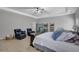 Spacious primary bedroom featuring a trey ceiling, ceiling fan, and sitting area with an oversized tv at 4251 Haywater Cv, Buford, GA 30519